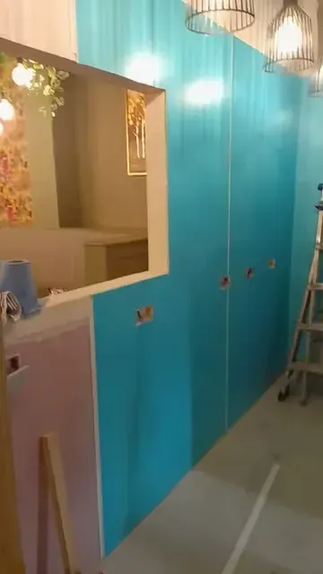 Blue bathroom wall board with large mirror recess, ladder, electrical/pipe openings and unfinished lower wall