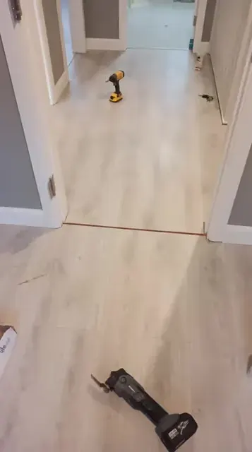 Pale wood-effect flooring through adjoining rooms