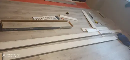 Wood-effect floor fitting with trims and tools