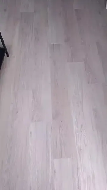 Pale wood-effect board flooring in a room