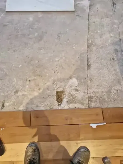 Existing floor covering lifted for preparation
