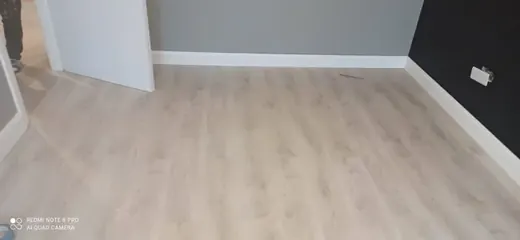Completed pale wood-effect flooring in a room