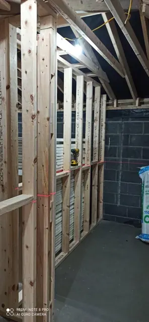 Timber stud partition in an attic