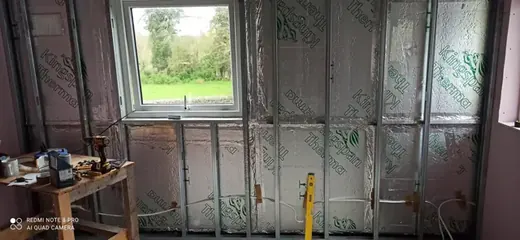 Metal stud framing and insulated wall before plasterboarding