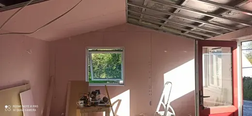 Room plasterboarding with walls fitted and ceiling underway