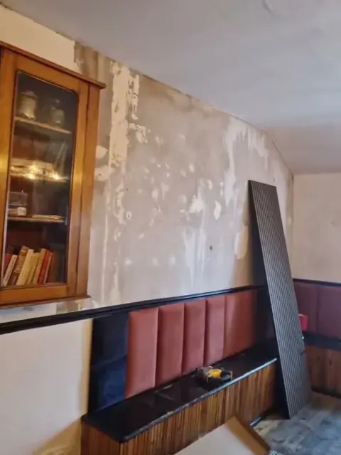 Stripped room walls during preparation for panelling