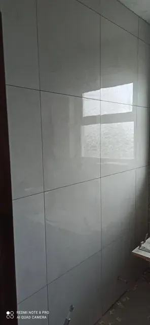 Grey wall tiles around a window and corner