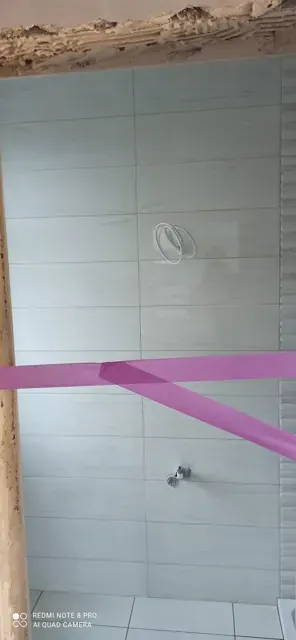 Grey wall tiling around bathroom connections